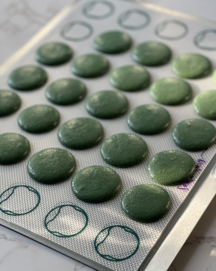 macarons on a baking sheet on table