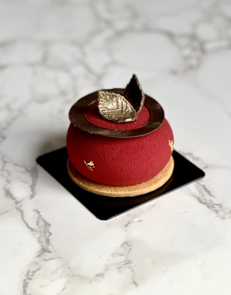 Cranberry walnut entremet on a marble counter 