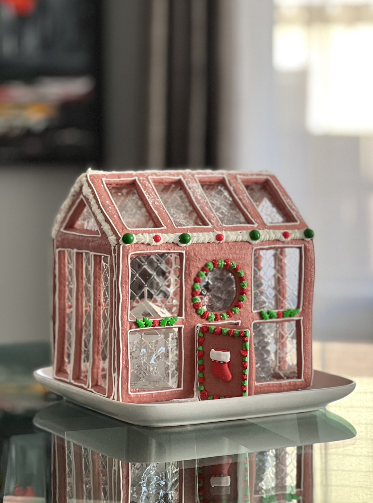 Macaron Gingerbread House  on a glass table 