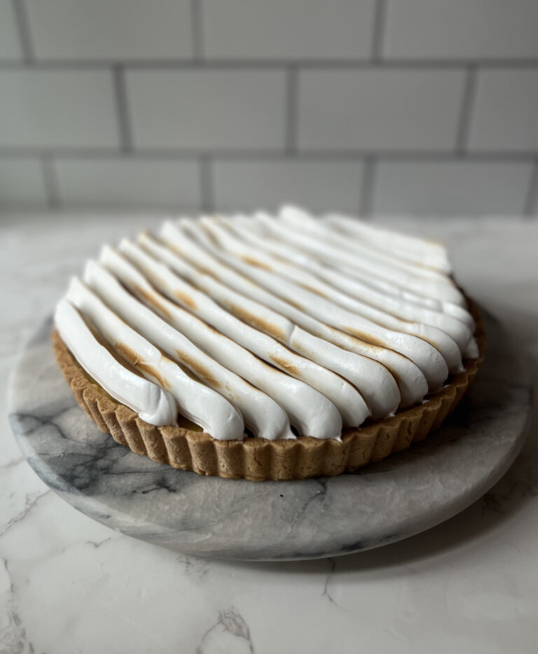 lemon meringue pie on a marble counter